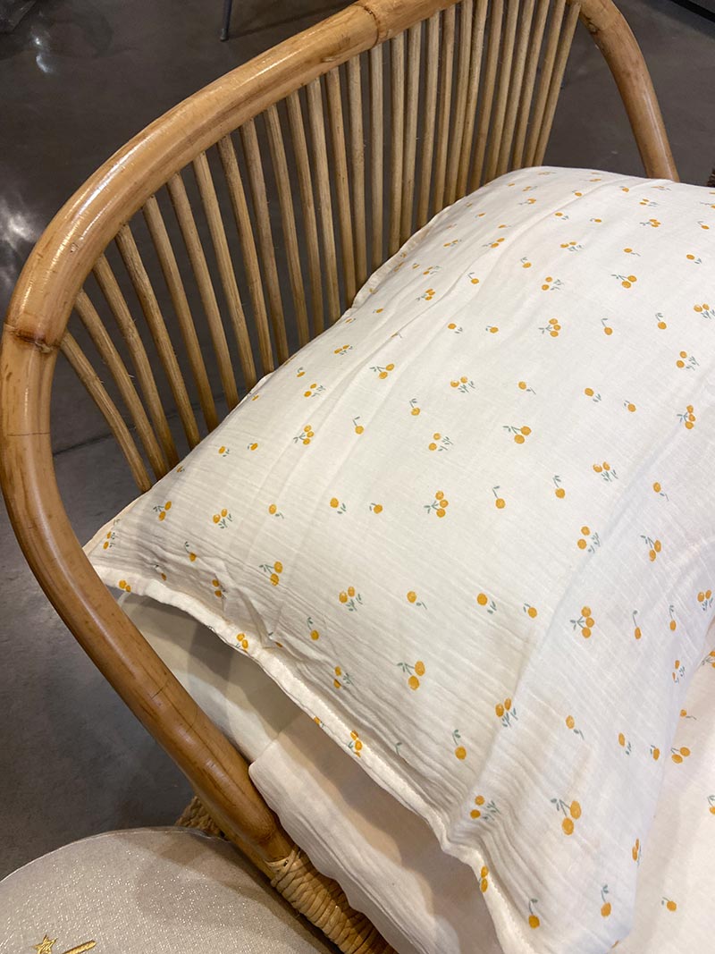 A rattan baby bed and a beautiful linen sheet set is the perfect combination